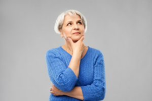 Woman in a questioning pose wondering if her dental implant feels pain